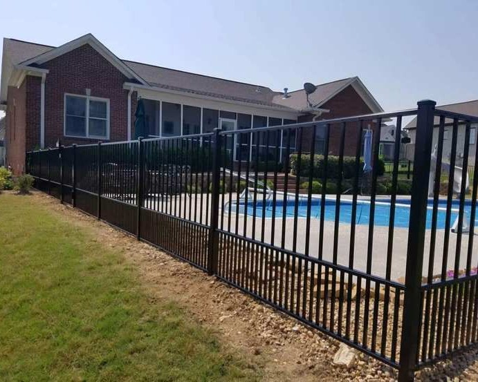 Black decorative aluminum fence around pool