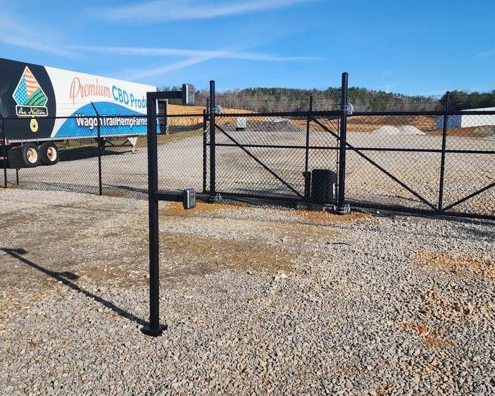 Chain link electric gate operator at work site.