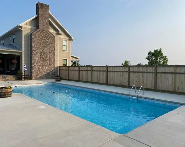 Wood privacy fence with pool.